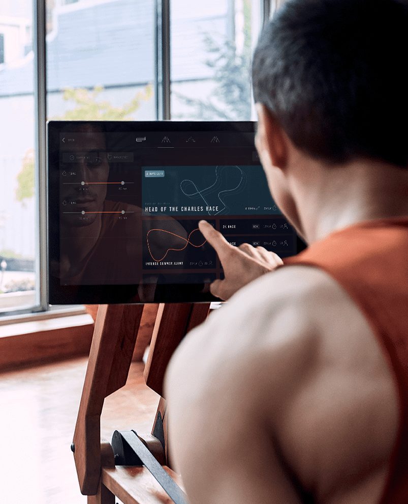 Man touching the tablet on the ergatta rower